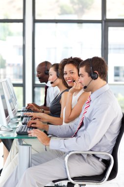 Smiling African-American businesswoman working in a call center clipart