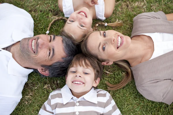 Tired family lying in a park — Stock Photo, Image