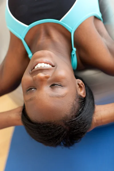 Smiling ethnic woman working out with a pilates ball — Stock Photo, Image