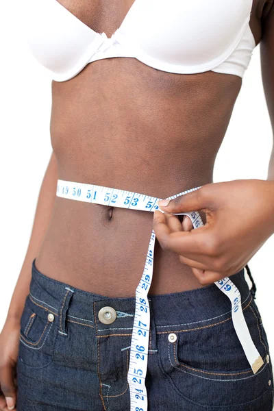 Woman measuring her waist with a tape measure — Stock Photo, Image