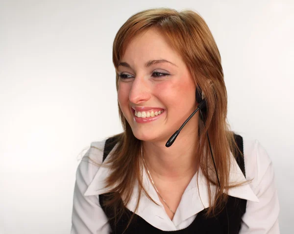 Kobieta na zestaw słuchawkowy mówić — Zdjęcie stockowe