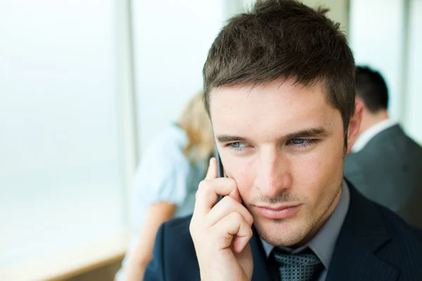 Serious businessman on phone in office — Stock Photo, Image