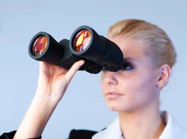 Serious business woman looking into Binoculars — Stock Photo, Image