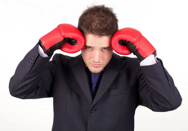 Businessman with boxing gloves to his head — Stock Photo, Image