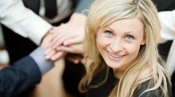 stock image High view of hands together and a businesswoman smiling at the camera. Concept of union in business