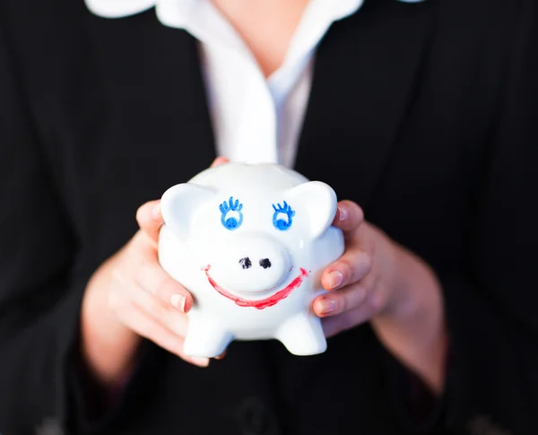 Young woman holding a funky piggy bank — Stock Photo, Image
