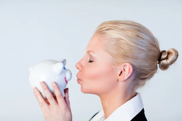 Woman kissing a piggy Bank — Stock Photo, Image
