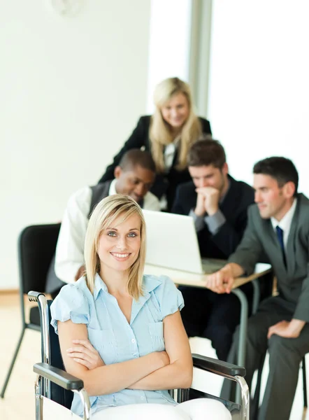 Beautiful manager with her team working in the background — Stock Photo, Image