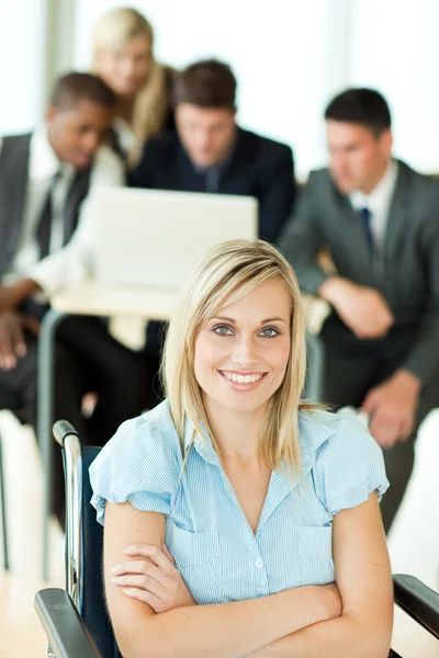 Confident businesswoman with her group working in the background — Stock Photo, Image