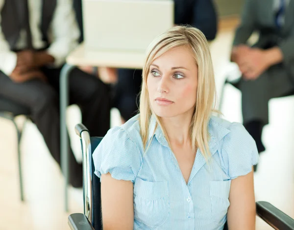 Thoughtful businesswoman with her colleagues in the background — Stock Photo, Image