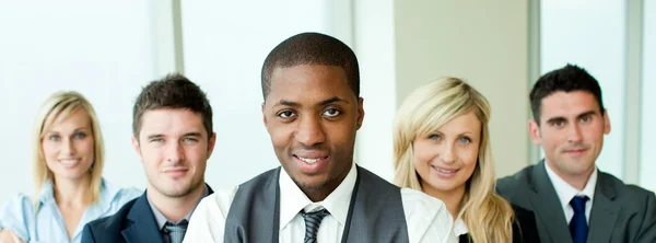 Business team in a row with ethnic manager in the center — Stock Photo, Image