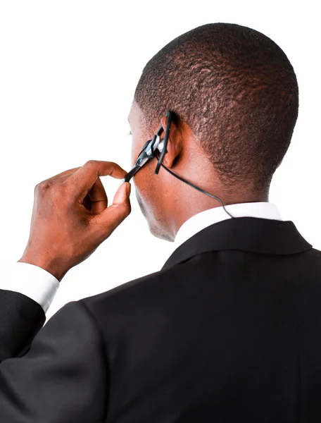 Businessman showing his earpiece — Stock Photo, Image