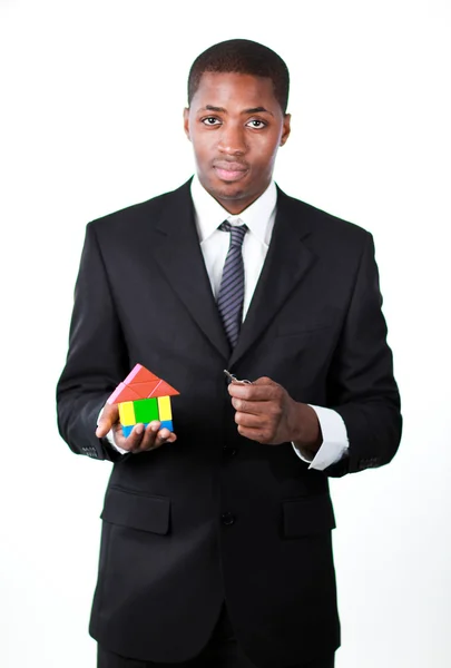 Confident businessman with a house for an real estate concept — Stock Photo, Image
