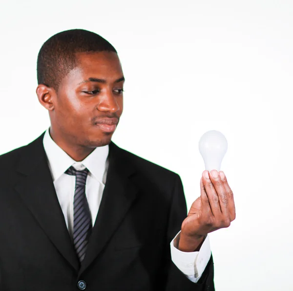 Confident businessman looking at a light bulb — Stock Photo, Image