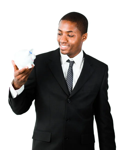 Young businessman looking at a piggy bank — Stock Photo, Image