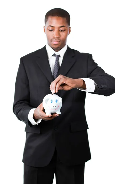 Portret van een zakenman die geld steken in zijn piggy bank — Stockfoto