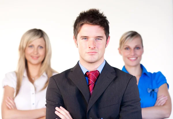 Confident businessman with businesswomen in the background — Stock Photo, Image