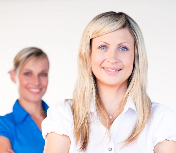 Businesswoman smiling at the camera with her colleague — Stock Photo, Image