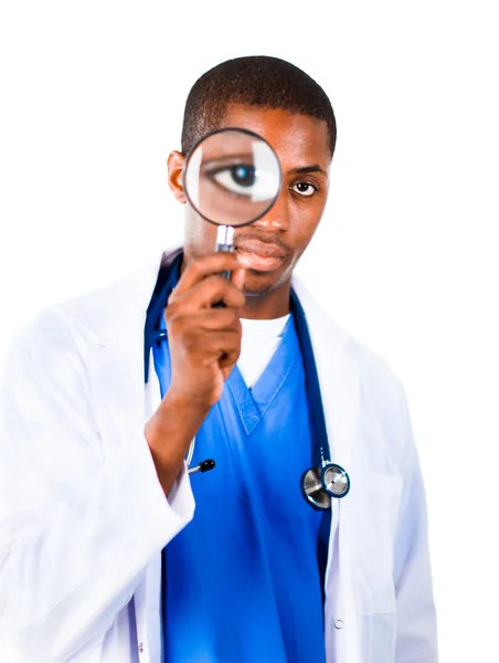 Confident doctor looking through a magnifying glass — Stock Photo, Image