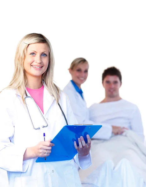 Beautiful young doctors with a patient — Stock Photo, Image