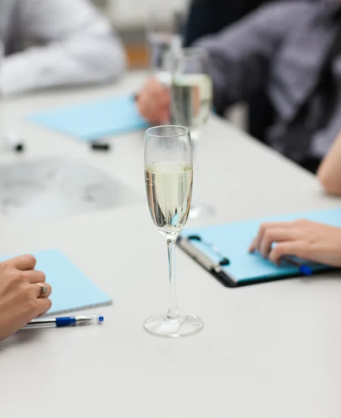A glass of champagne in office — Stock Photo, Image