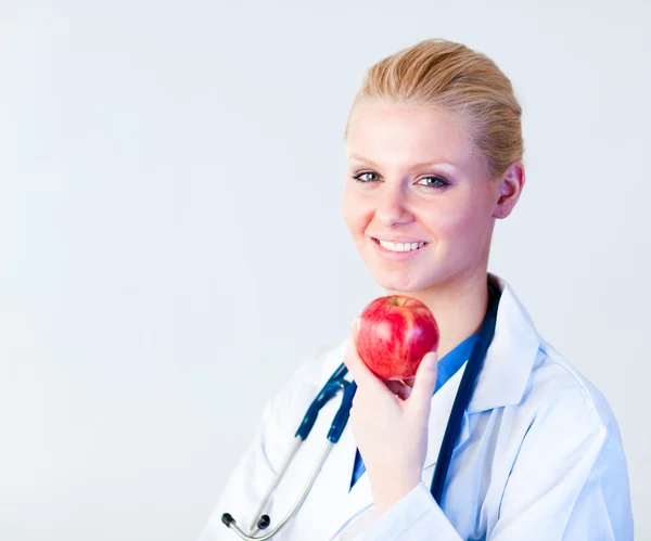 Doctor holding an apple with focus on person — Stock Photo, Image