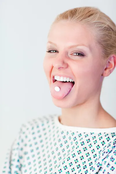 Patient with a pill in her mouth — Stock Photo, Image