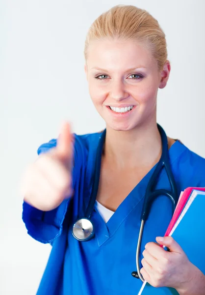 Doctor with her thumb up with focus on face — Stock Photo, Image