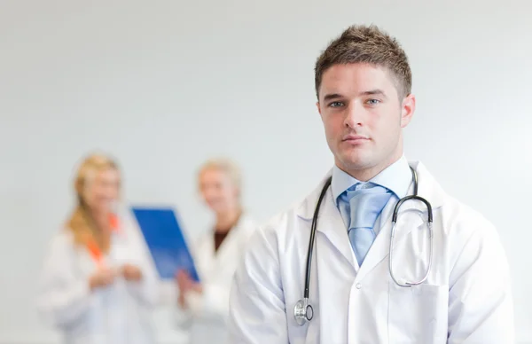 Self-assured male surgeon with his team behind him — Stock Photo, Image