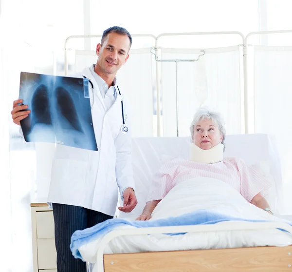Doktor ukazující rentgen pacientovi — Stock fotografie