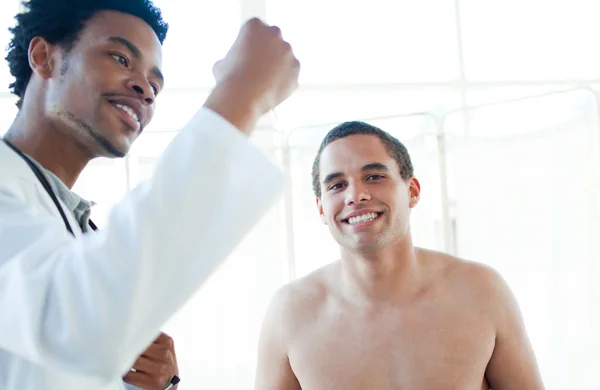 Afro-american doctor checking patient's temperature — 스톡 사진