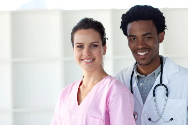 A doctor and a nurse smiling at the camera — Stock Photo, Image