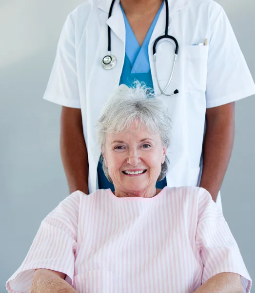 Smiling senior patient sitting on a wheelchair — Stock Photo, Image