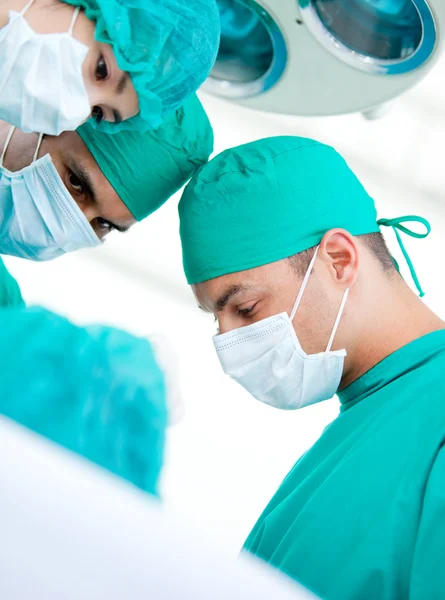 Multi-ethnic madical team working on a patient — Stock Photo, Image