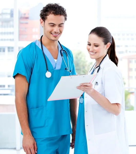 Happy medical partners looking at the diagnosis — Stock Photo, Image