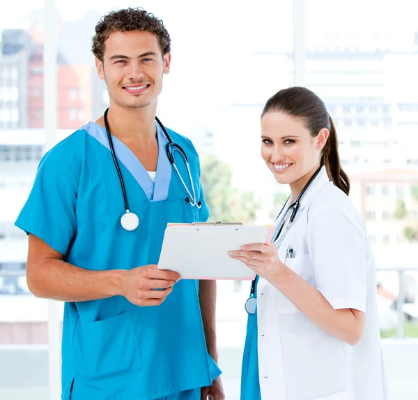 Smiling partners holding a patient diagnosis — Stock Photo, Image