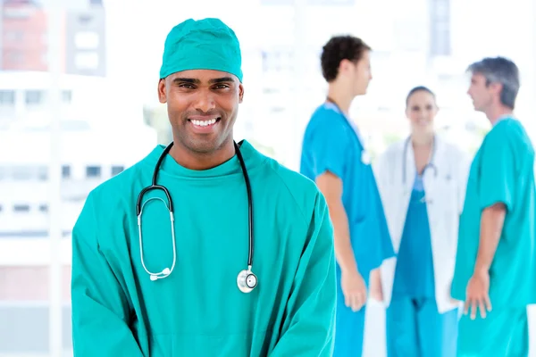 Afro male doctor looking at the camera while his medical partner — Stock Photo, Image