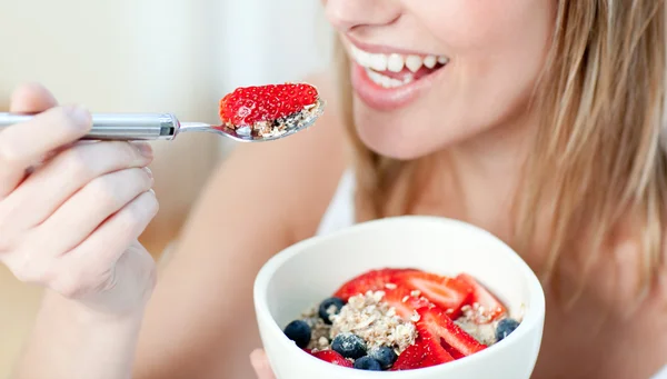 Close-up of a woman eating muesli with fruits — Stock Photo, Image