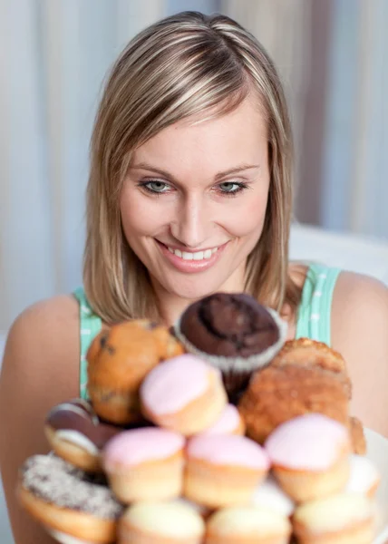 Mulher encantadora segurando um prato de bolos — Fotografia de Stock
