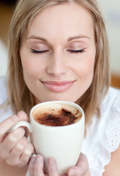Delighted woman drinking a coffee — Stock Photo, Image