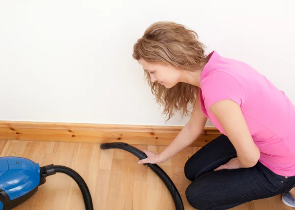 Portrait of a charming woman vacuuming — Stock Photo, Image