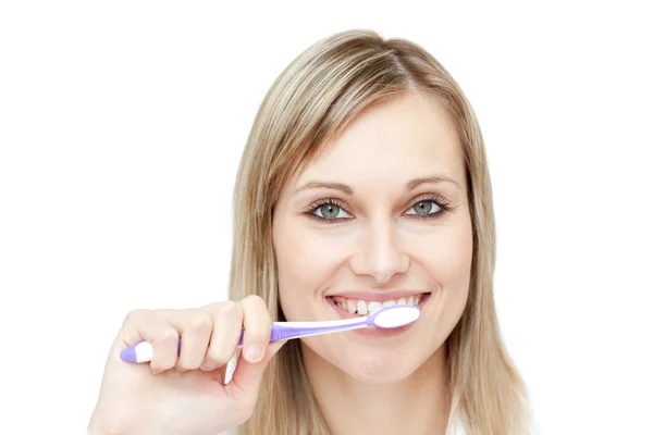 Portrait of a blond woman brushing her teeth — Stock Photo, Image