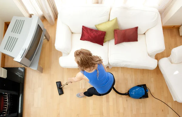 High angle of a blond woman vacuuming — Stock Photo, Image
