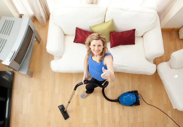 High angle of a cheerful woman vacuuming — Stock Photo, Image