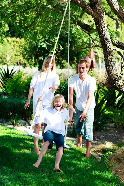 Father, mother and son swinging — Stock Photo, Image