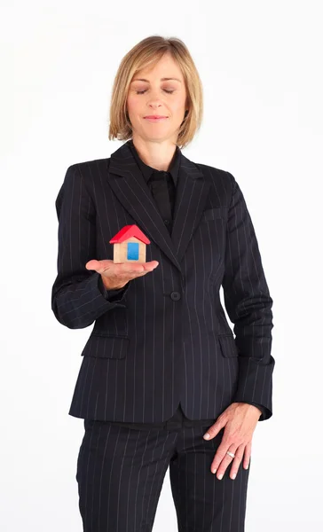 Confident businesswoman holding a house — Stock Photo, Image