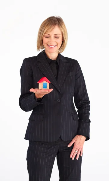 Frinedly mature businesswoman holding a house — Stock Photo, Image