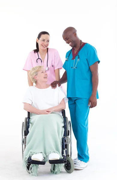 NUrse and doctor with a patient in a wheel chair — Stock Photo, Image