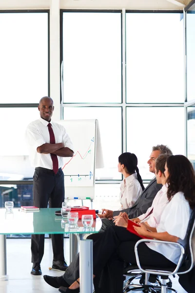 Attractive businessman with folded arms in a meeting — Stock Photo, Image