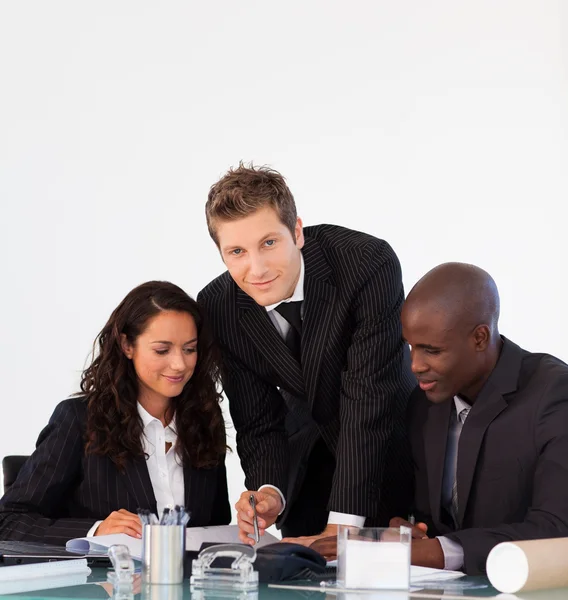Business discussing in an office and looking at the camer — Stock Photo, Image